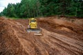 Dozer during clearing forest for construction new road . Yellow Bulldozer at forestry work Earth-moving equipment at road work, Royalty Free Stock Photo