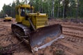 Dozer during clearing forest for construction new road . Yellow Bulldozer at forestry work Earth-moving equipment at road work, Royalty Free Stock Photo