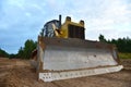 Dozer during clearing forest for construction new road . Yellow Bulldozer at forestry work Earth-moving equipment at road work, Royalty Free Stock Photo