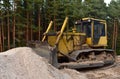 Dozer on road construction and bridge projects in forest area. Heavy machinery for road work. Building a road works. Leveling and