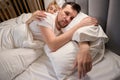 Dozing wife hugs her upset husband