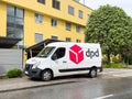 Dpd delivery van parked outside yellow building on rainy day Royalty Free Stock Photo