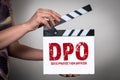DPO Data Protection Officer Concept. Female hands holding movie clapper Royalty Free Stock Photo