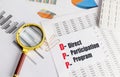 DPP acronym explained as direct participation program on paper with charts, magnifying glass and calculator Royalty Free Stock Photo