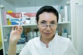 Dr. cometologist. A woman prepares a syringe with medication to correct wrinkles