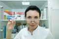 Dr. cometologist. A woman prepares a syringe with medication to correct wrinkles