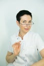 Dr. cometologist. A woman prepares a syringe with medication to correct wrinkles