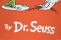 By Dr. Seuss on the front cover of an orange book