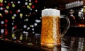 Draft or craft beer in tall clear glass. With cold steam, White beer foam placed on a wooden floor, behind the background is a Royalty Free Stock Photo