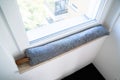 Draft Excluder Under Window Blocking Cold Air Royalty Free Stock Photo