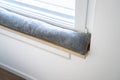 Draft Excluder Under Window Blocking Cold Air Royalty Free Stock Photo