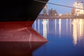 Draft marks on a ship - waterline numbers on bow and stern of a vessel at seaport at night