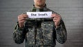 The draft written on sign in soldier hands, compulsory military service, duty