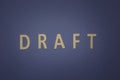 Draft written with wooden letters on a blue background