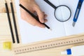 Draftsman workplace equipped with ruler, pen, stapler, scissors, magnifying glass. Royalty Free Stock Photo