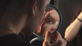 Drag artist - young man doing his eyebrows using glue Royalty Free Stock Photo