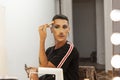 Drag queen artist doing her makeup in the dressing room Royalty Free Stock Photo