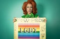 Drag queen celebrating gay pride holding banner with rainbow flag Royalty Free Stock Photo