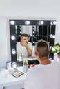 Drag queen performer applying makeup while getting ready in the dressing room. Royalty Free Stock Photo