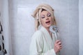 Drag queen person singing using shower head as a microphone. Royalty Free Stock Photo