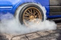 Drag racing car burning tire at starting line in race track Royalty Free Stock Photo