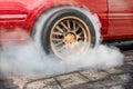 Drag racing car burning tire at starting line in race track Royalty Free Stock Photo