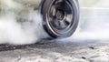 Drag racing car burning tire at starting line in race track Royalty Free Stock Photo