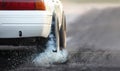 Drag racing car burns rubber off its tires in preparation for the race