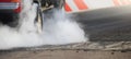 Drag racing car burns tires preparation for the race