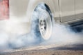 Drag racing car burns tires preparation for the race