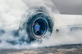 Drag racing car burns its tires in preparation for the race Royalty Free Stock Photo