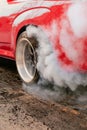 Drag racing car burns tires in preparation for the race Royalty Free Stock Photo