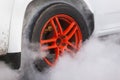 Drag racing car burns rubber off its tires in preparation for the race Royalty Free Stock Photo