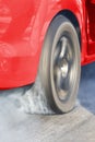 Drag racing car burns rubber off its tires Royalty Free Stock Photo