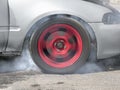 Drag racing car burns rubber off its tires Royalty Free Stock Photo