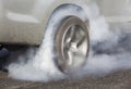 Drag racing car burns rubber off its tires Royalty Free Stock Photo