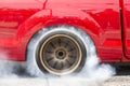 Drag racing car burns rubber off its tires Royalty Free Stock Photo