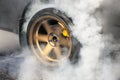 Drag racing car burns tires for the race