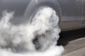 Drag racing car burns rubber off its tires Royalty Free Stock Photo