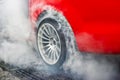 Drag racing car burns tires at start line. Royalty Free Stock Photo