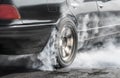 Drag racing car burns tires in preparation for the race Royalty Free Stock Photo