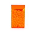 Dragee in orange container Royalty Free Stock Photo