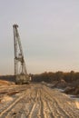 A dragline excavator in a sand quarry. Phosphorite Mine. Tire tracks on a sand Royalty Free Stock Photo