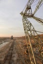 A dragline excavator and a stacker in a sand quarry. Old abandoned railway track. Phosphorite Mine