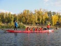 Dragon boat racing. Dragon boat participant practice paddling during sunset golden hour. Russia, Saratov - September 2019 Royalty Free Stock Photo