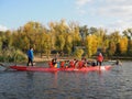 Dragon boat racing. Dragon boat participant practice paddling during sunset golden hour. Russia, Saratov - September 2019 Royalty Free Stock Photo