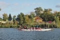 Dragon boat racing. Dragon boat participant practice paddling during sunset golden hour. Russia, Saratov - September 2019 Royalty Free Stock Photo