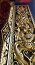 Dragon carving on temple windor cover with Thai Art design with Lacquer coated Real Gold Leaf in royal temple Bangkok Thailand