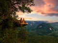 Dragon Crest mountain Krabi Thailand, a Young traveler sits on a rock that overhangs the abyss, with a beautiful