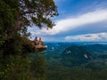 Dragon Crest mountain Krabi Thailand, a Young traveler sits on a rock that overhangs the abyss, with a beautiful Royalty Free Stock Photo